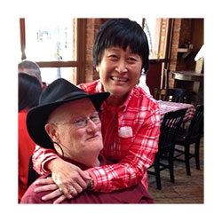 Elizabeht is hugging a gentleman