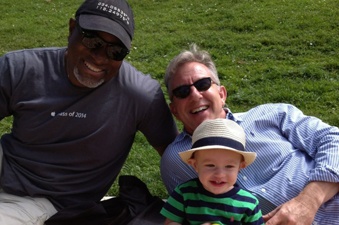 Tom Harshman relaxing with family on a grassy lawn