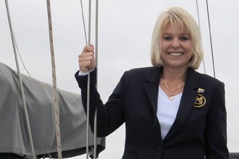 Julie Simer smiles from the deck of a sailboat