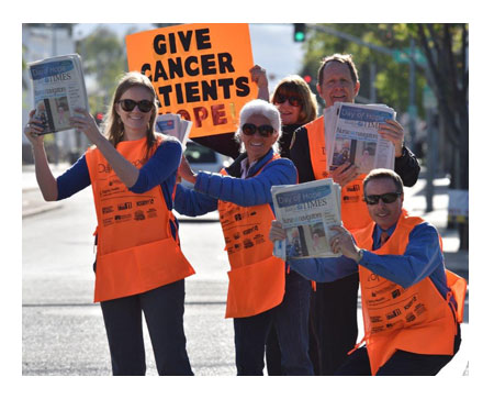 Day of Hope team members selling paper