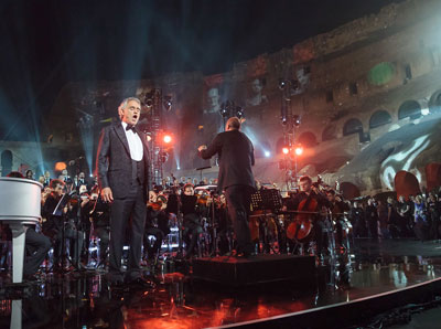 Singer Andrea Bocelli sings from a stage at the Coliseum in Rome