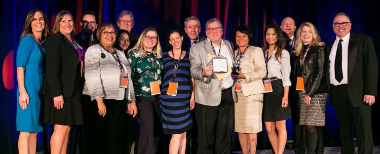 A group of Phillie award winners pose on stage with Senior Vice President for Philanthropy, Fred Najjar