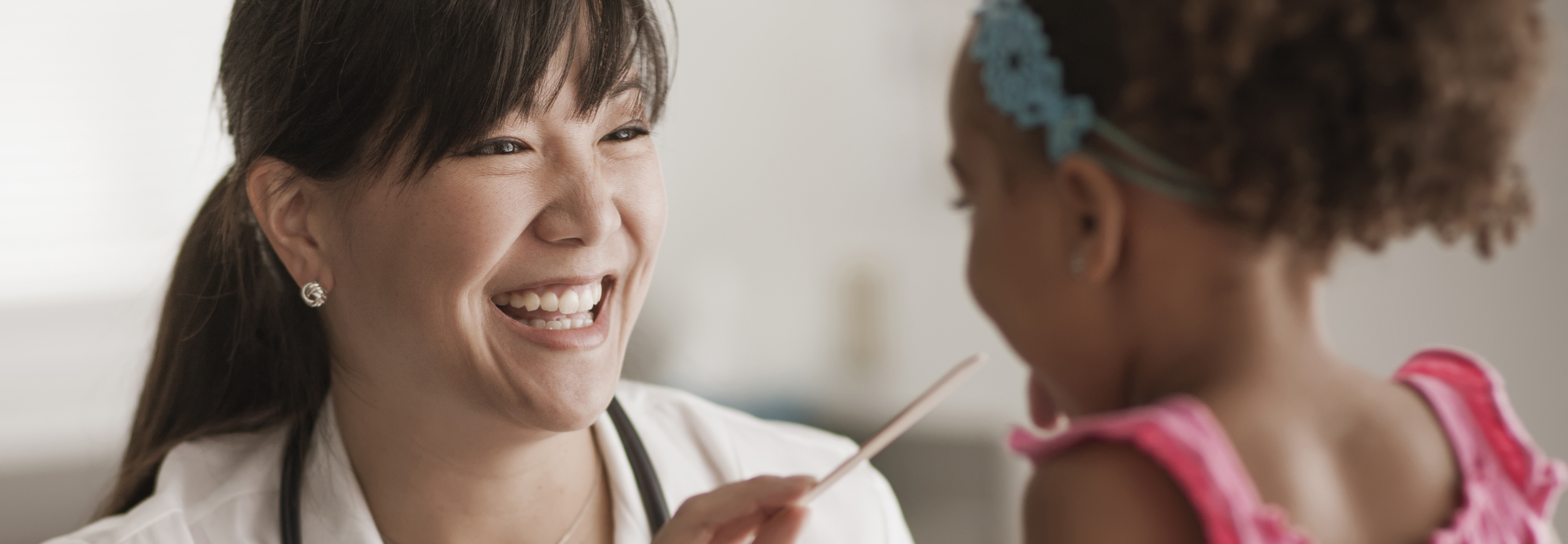 Female doctor smiling at a child